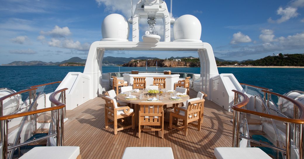 circular dining table on sundeck of luxury yacht SUNRISE