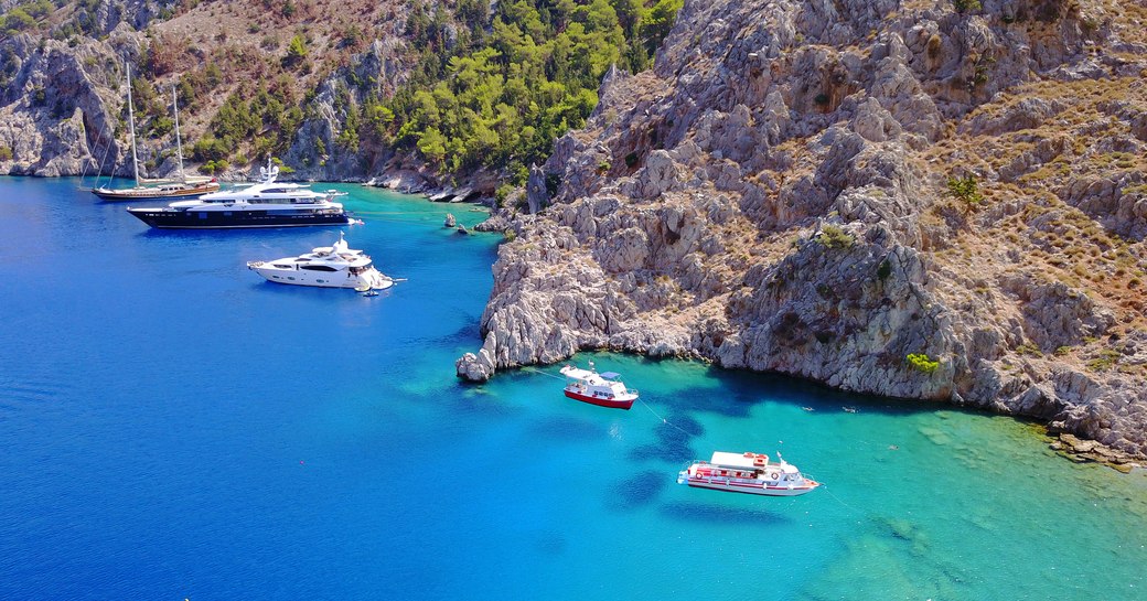 Yachts anchored in a sheltered cove in Greece