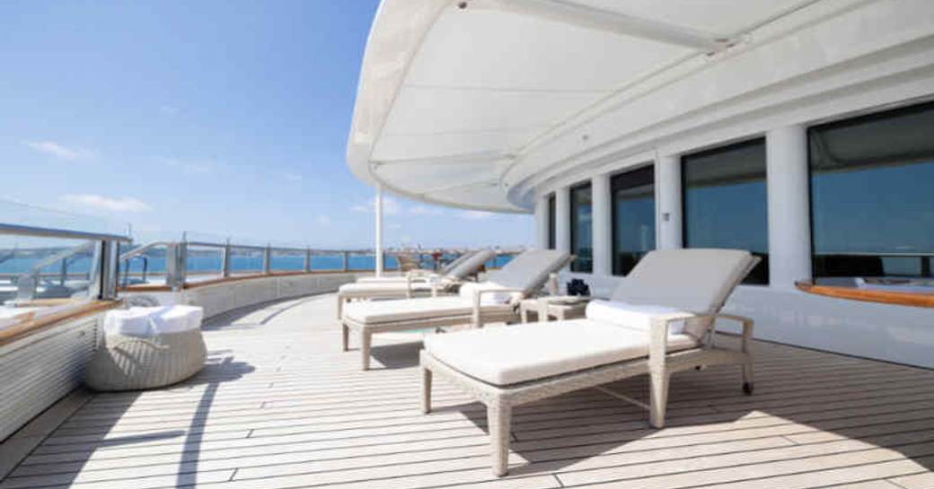 Sun loungers lined up on the deck onboard charter yacht TATOOSH