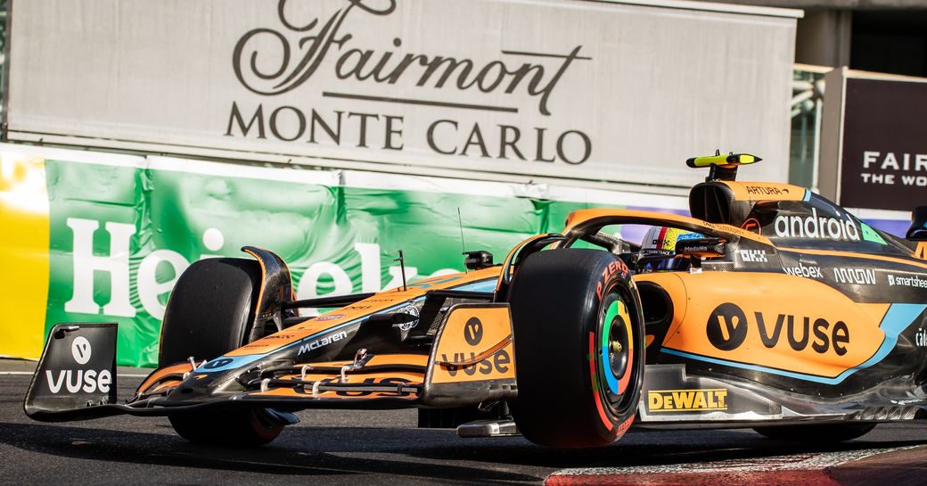 Monaco Grand Prix racer speeding round the track by a 'Fairmont Monte Carlo' sign.