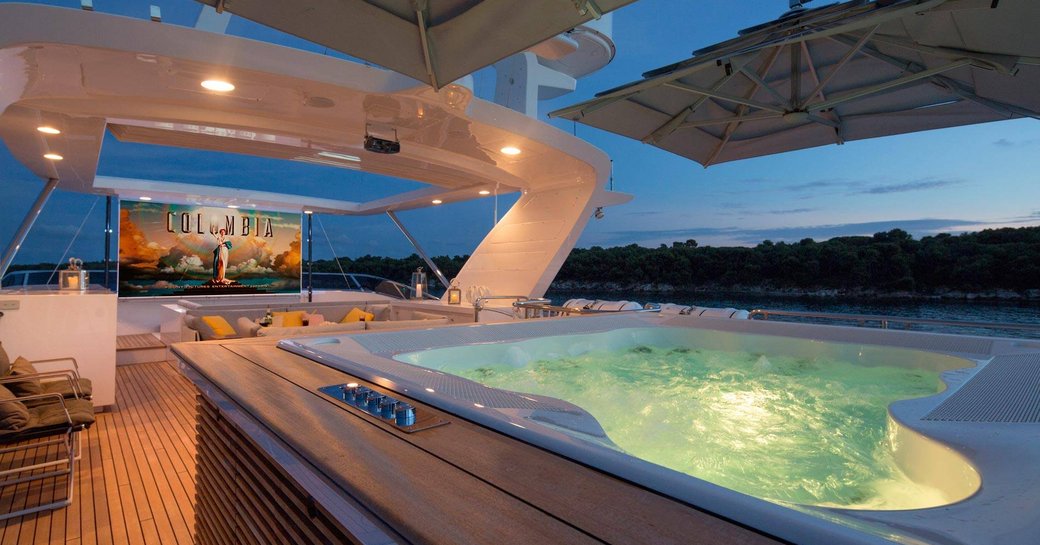 sundeck on board superyacht DYNAR transforms into a open-air cinema at night