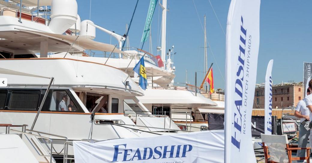 Feadship yachts and banners at the MYBA Charter Show