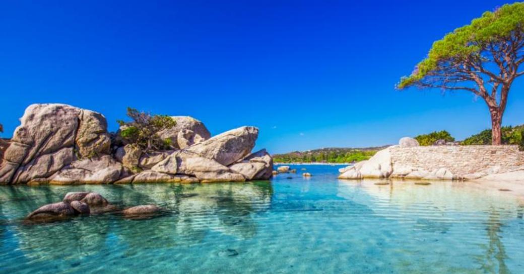 Shallow bay with blue water on french island of corsica