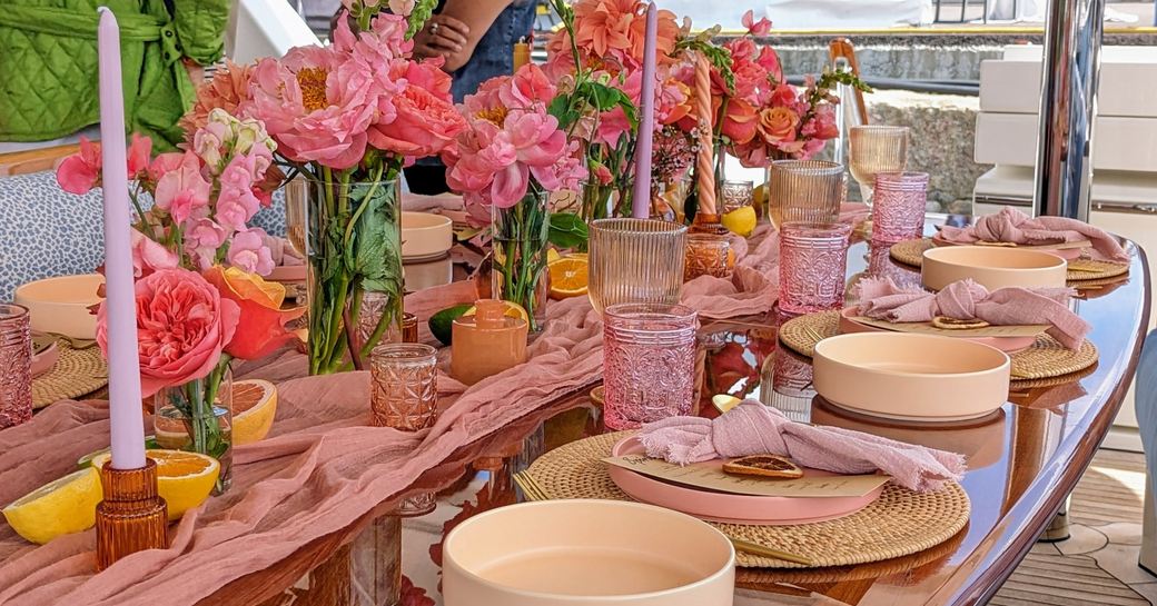 Tablescaping entry to a competition at the Newport Charter Yacht Show, with pink florals and matching napkins