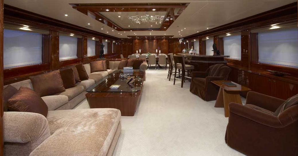 cherrywood wall panels and sofa and armchairs in the main salon of superyacht Lady Leila 