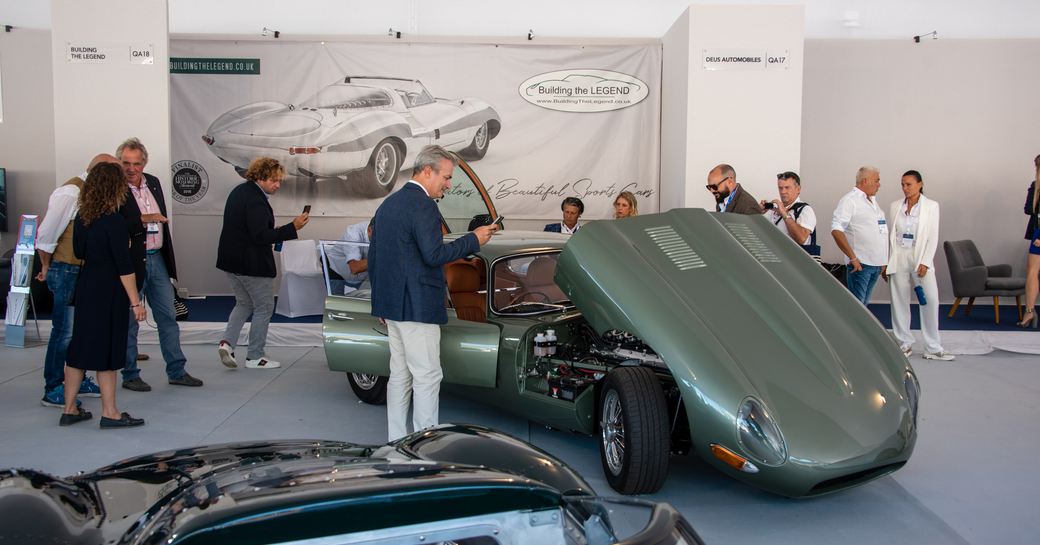 Man taking picture of luxury vintage car at Monaco Show 