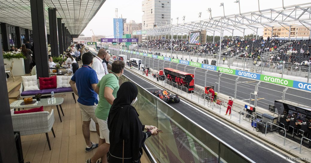 Overview of Saudi Arabia Grand Prix viewpoint, watching over the track. Group of visitors leaning on the railings looking down to the action on the course.