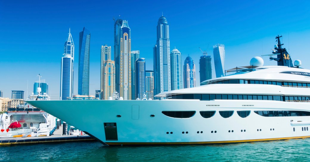 superyacht lines up in Dubai waters against iconic cityscape