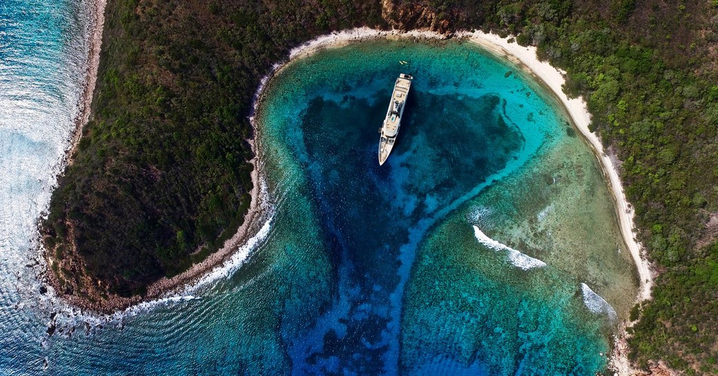 charter yacht come together in a remote cove in the Caribbean