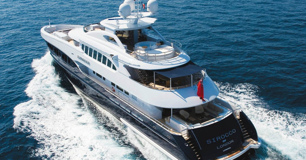 Rear aerial view of motor yacht Sirocco in motion, cutting through waves