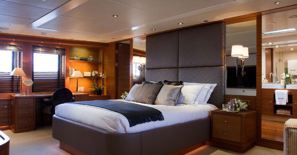 Master cabin onboard charter yacht Shake N Bake, central berth facing forward with windows to port.