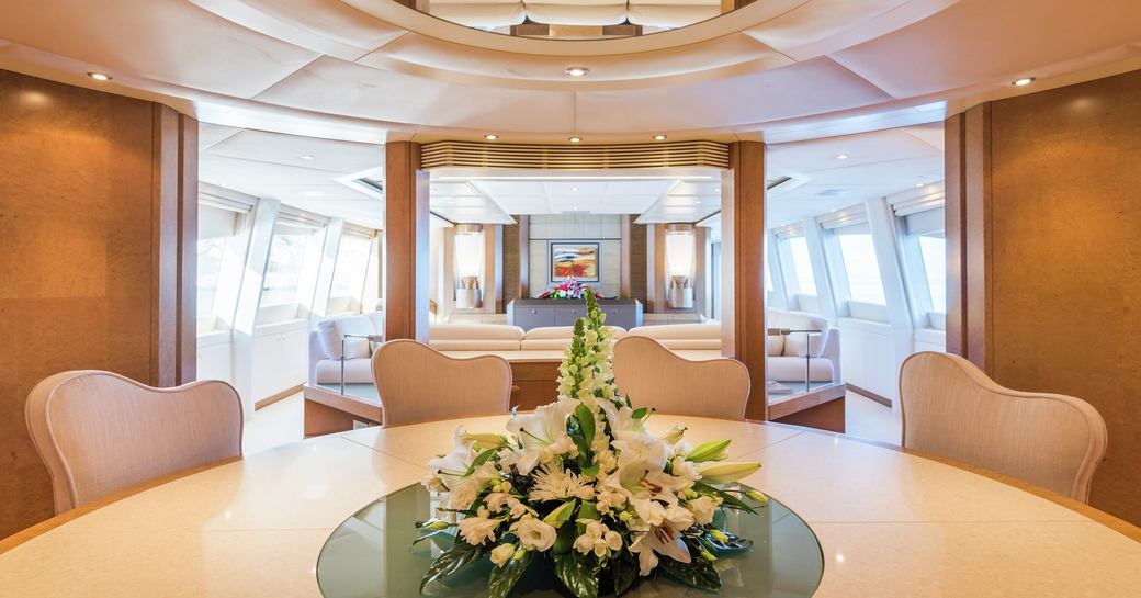 dining room on luxury yacht benita blue with flowers in middle of table 
