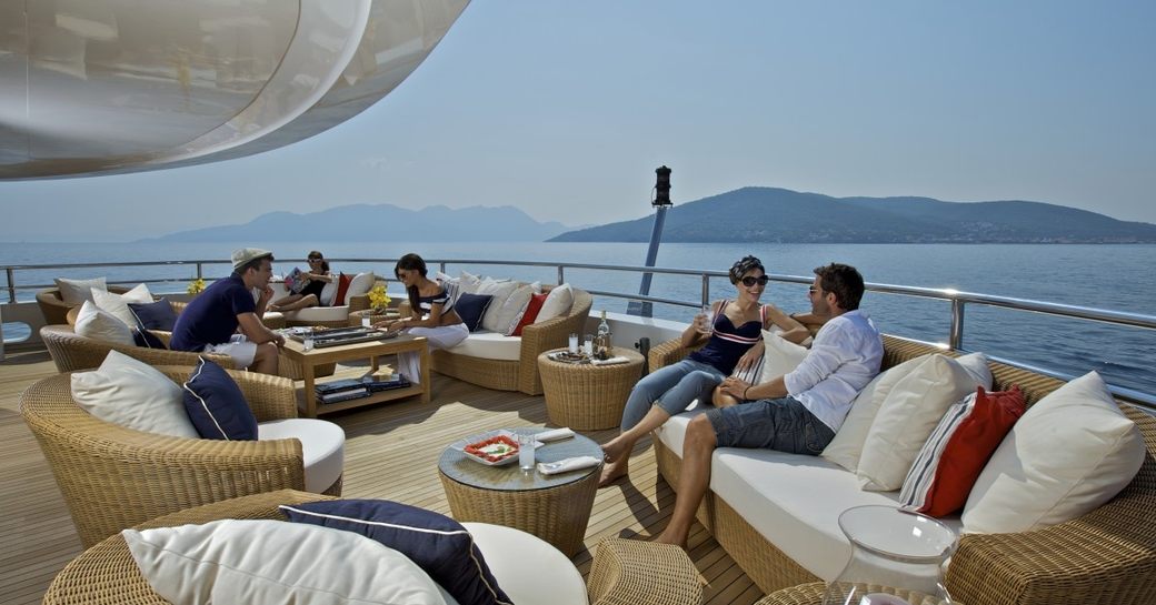 Guests relax on O'MEGA's sun deck