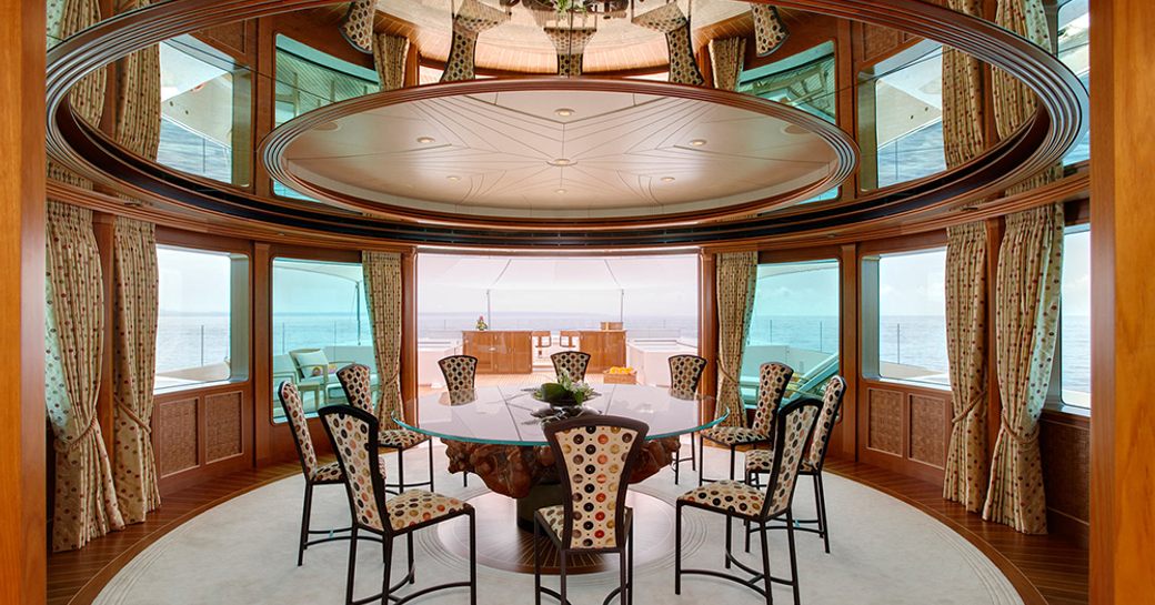 Lavish Key West lounge with dining table on upperdeck of superyacht ‘Lady Christine’ 