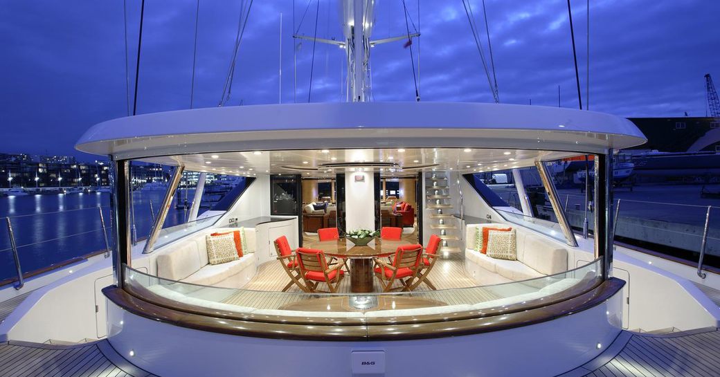 Spacious cockpit dining area with huge windows on board superyacht Q