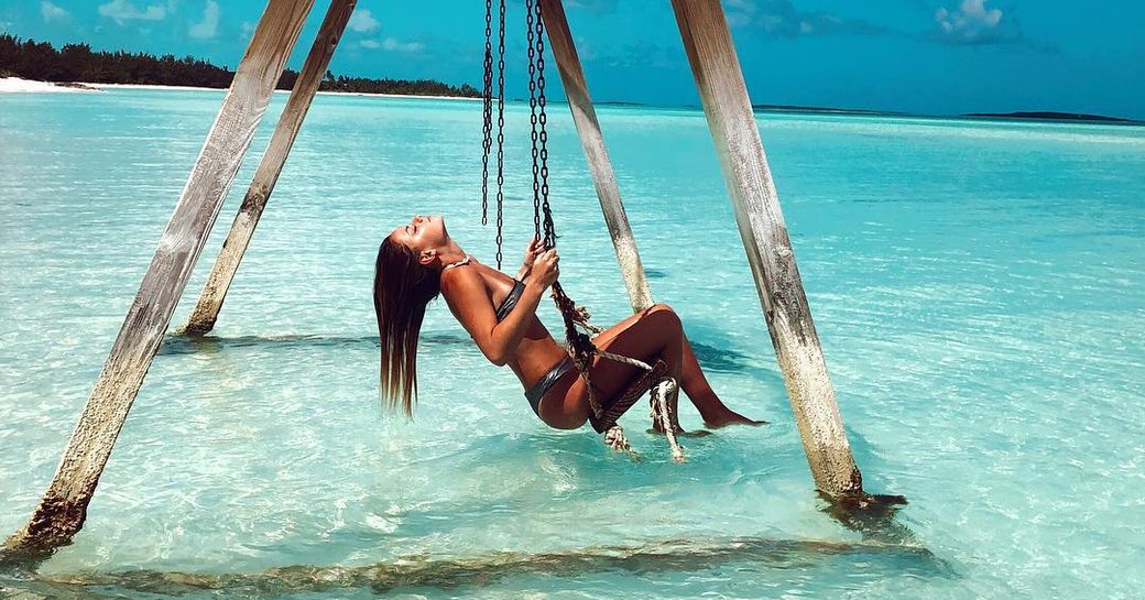woman on a swing in blue waters