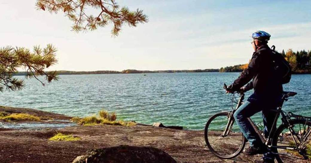 A man on a bike contemplates the sea in Hanko, Finland