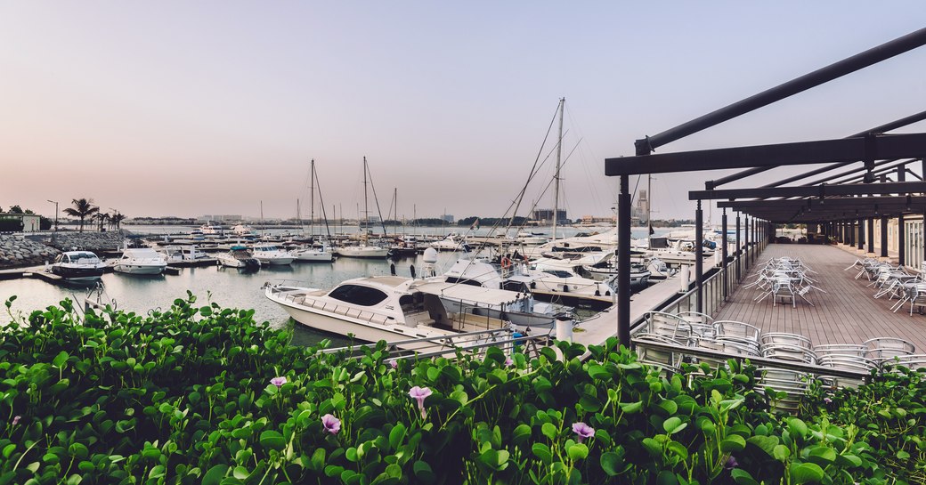 Al Hamra Village in Ras al Khaimah, United Arab Emirates. Persian gulf marina, pier, boats and yacht club of RAK emirate in a luxury life style community Al Hamra Village.