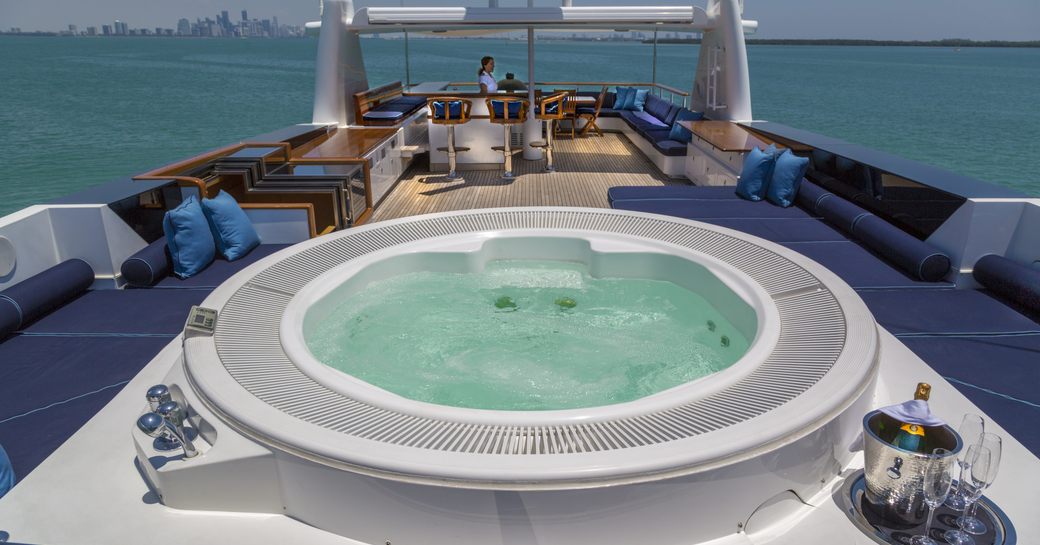 Spa pool on the sun deck of superyacht Ice 5, surrounded by sun pads