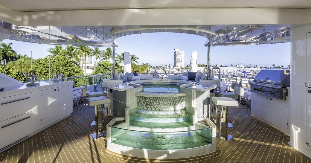Waterfall Jacuzzi with swim-up bar on sundeck of motor yacht King Baby 