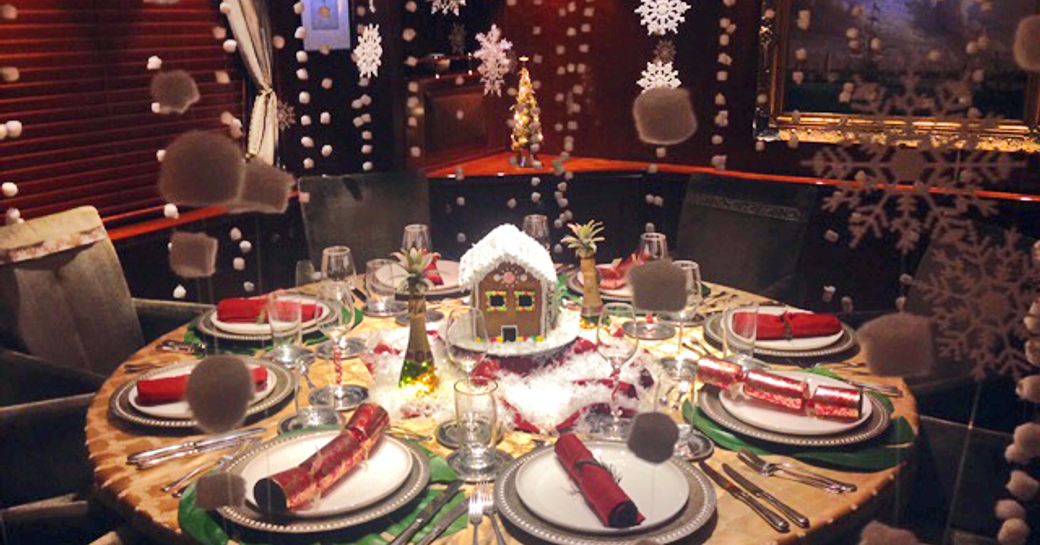 Christmas snow globe scene on dining table on luxury yacht Zeepaard