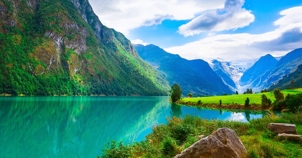 beautiful mountain and blue waters found in the Norwegian Fjords