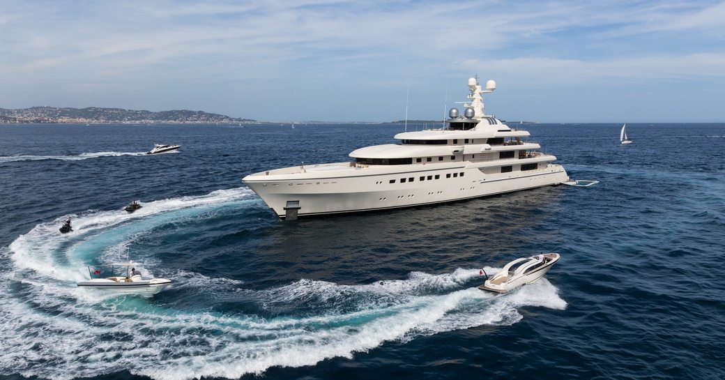 Megayacht ROMEA on the water, surrounding by toys and tenders