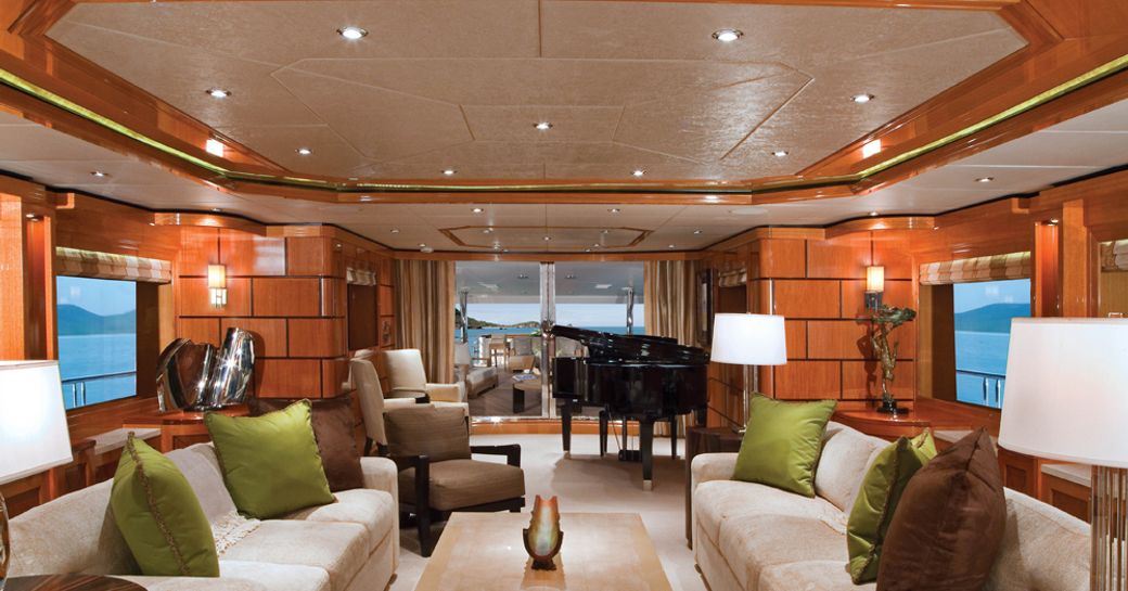 main salon with sofas and piano on board superyacht IMPROMPTU 