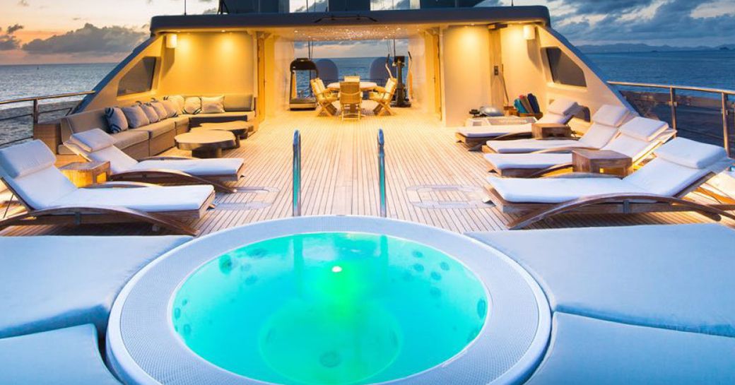Superyacht O'MEGA with sunpads and jacuzzi and shaded dining space