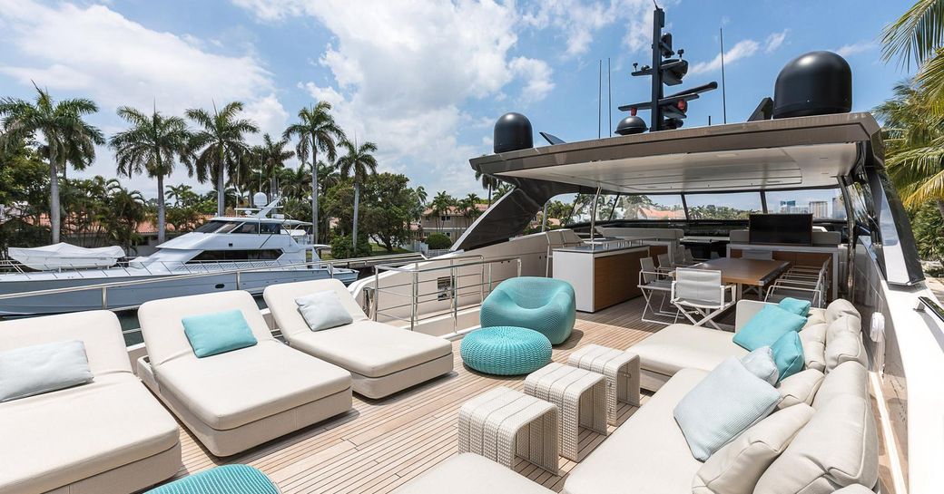 open and capacious flybridge of charter yacht freddy with sumptuous seating and turwuoise embelishments 
