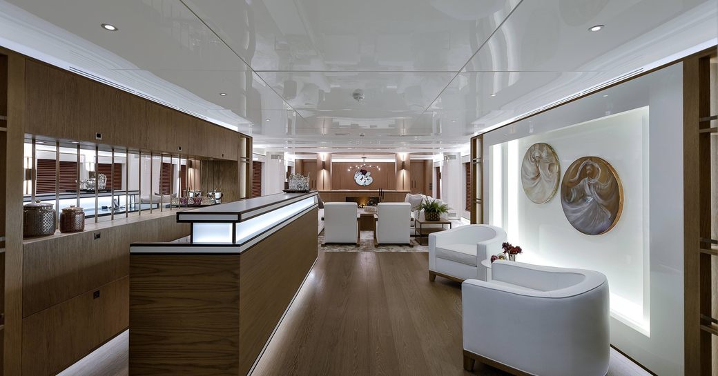 Main salon of luxury yacht Liquid Sky with bespoke wall furnishings
