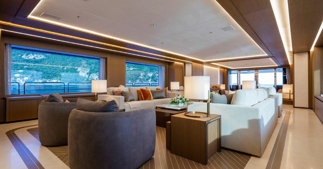 Main salon onboard charter yacht ALFA, spacious lounge area surrounded by large windows