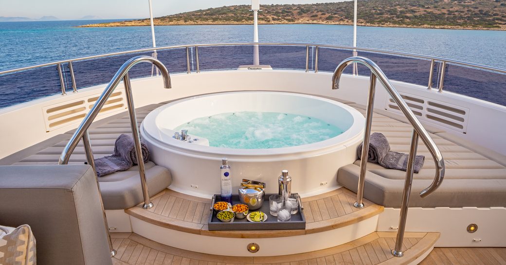 Deck Jacuzzi surrounded by sun pads onboard charter yacht AQUA LIBRA