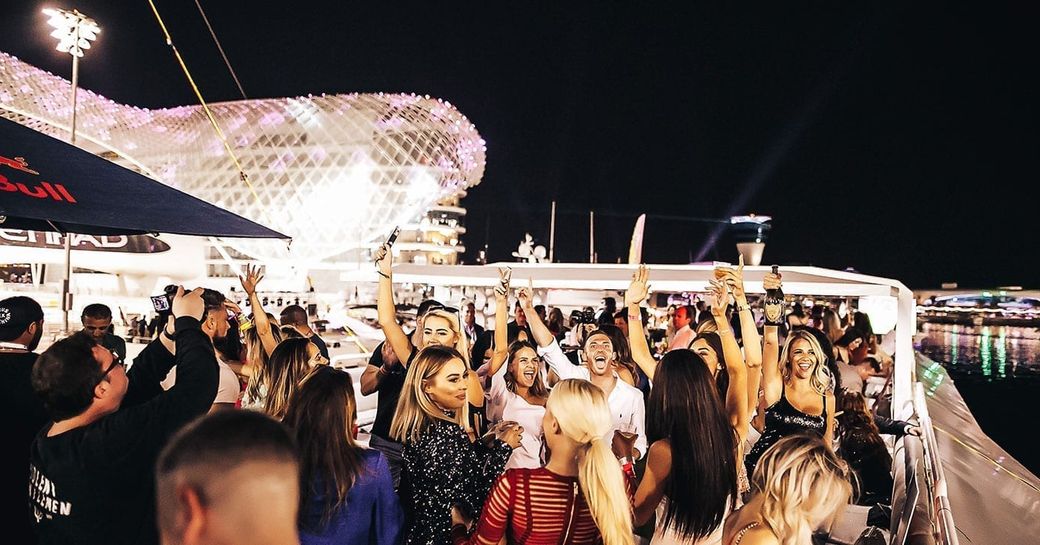 people celebrating on a yacht party in Yas Marina, Abu Dhabi at the Grand Prix