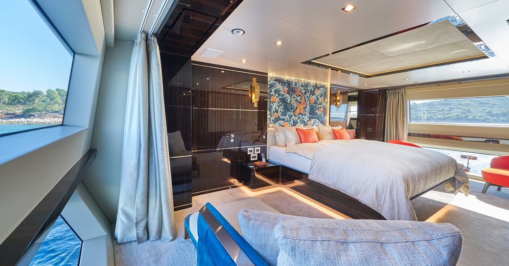 Master cabin onboard charter yacht HAPPY ME, central forward facing berth with large windows to either side of the cabin