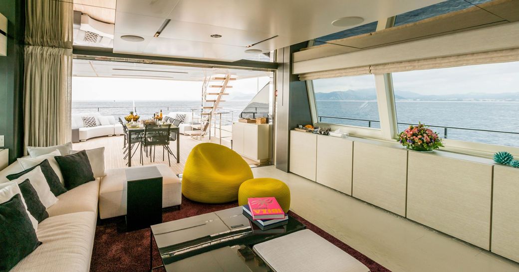 deep sofa in the skylounge of superyacht December Six which opens onto upper deck aft