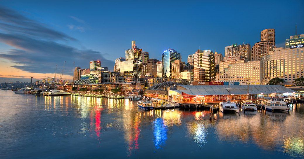 upmarket bars and restaurants line King Street Wharf as the sun sets over Sydney Harbour