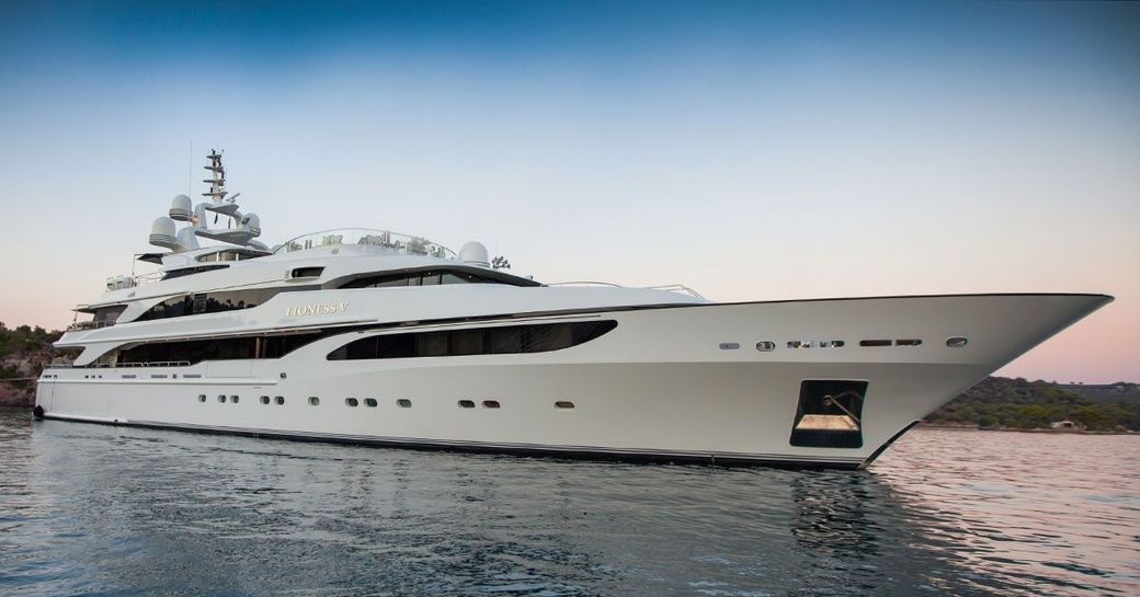 ‘Lioness V’ anchors in the Caribbean as the sun begins to set on a private yacht charter
