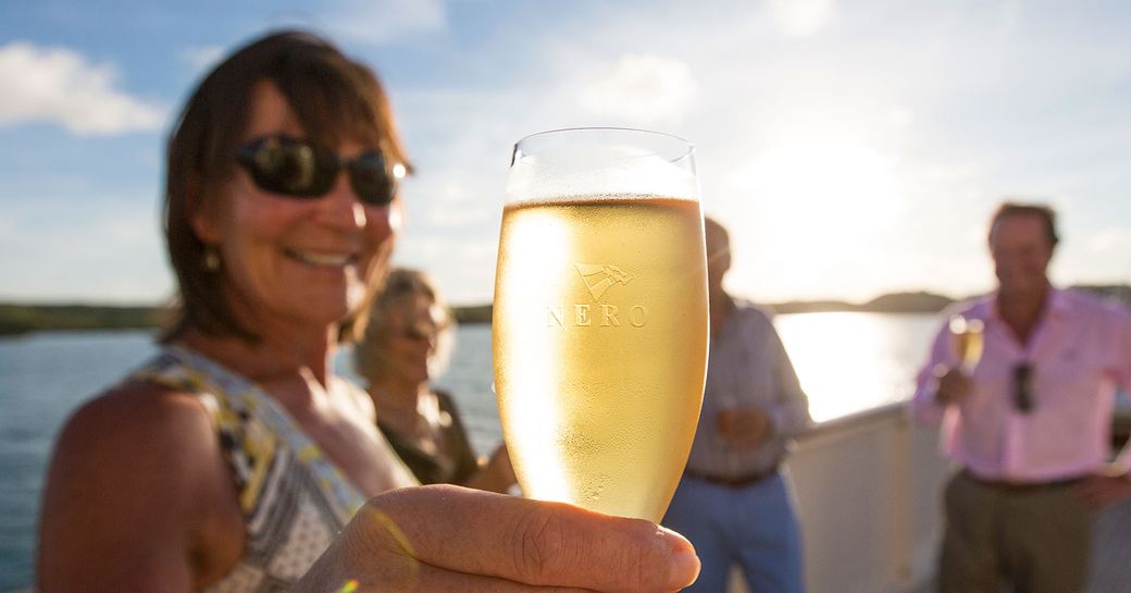 Guests enjoying champagne on board charter yacht NERO