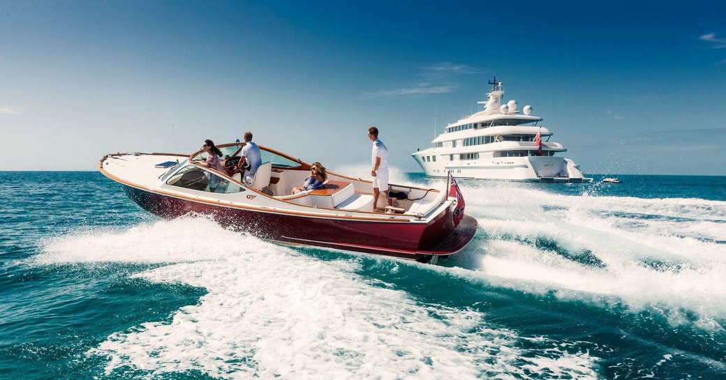 charter guests make their way to superyacht Lady E on a tender