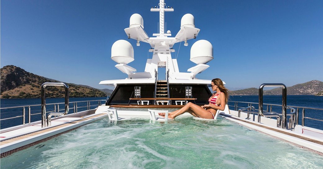 Lady relaxing in infinity pool on Superyacht AXIOMA