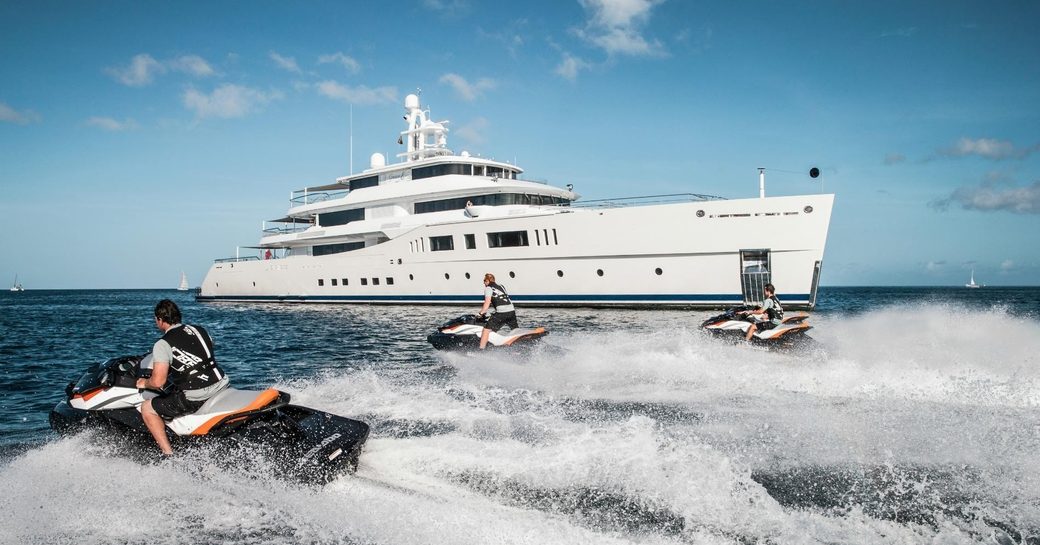 charter guests play on jet skis as superyacht ‘Grace E’ anchors nearby