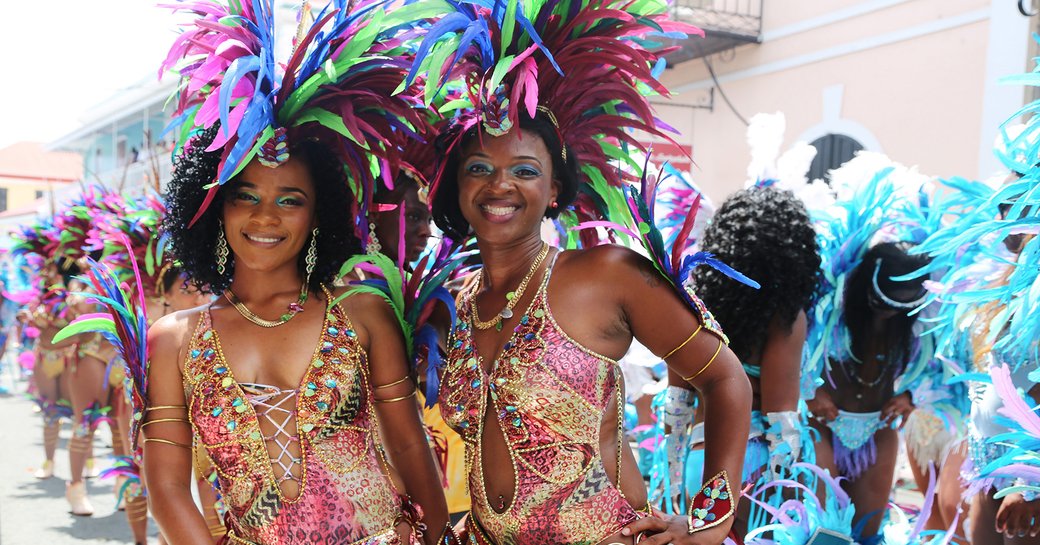 Two locals dressed head to toe in feathers and beads at the St Thomas Carnival, Caribbean