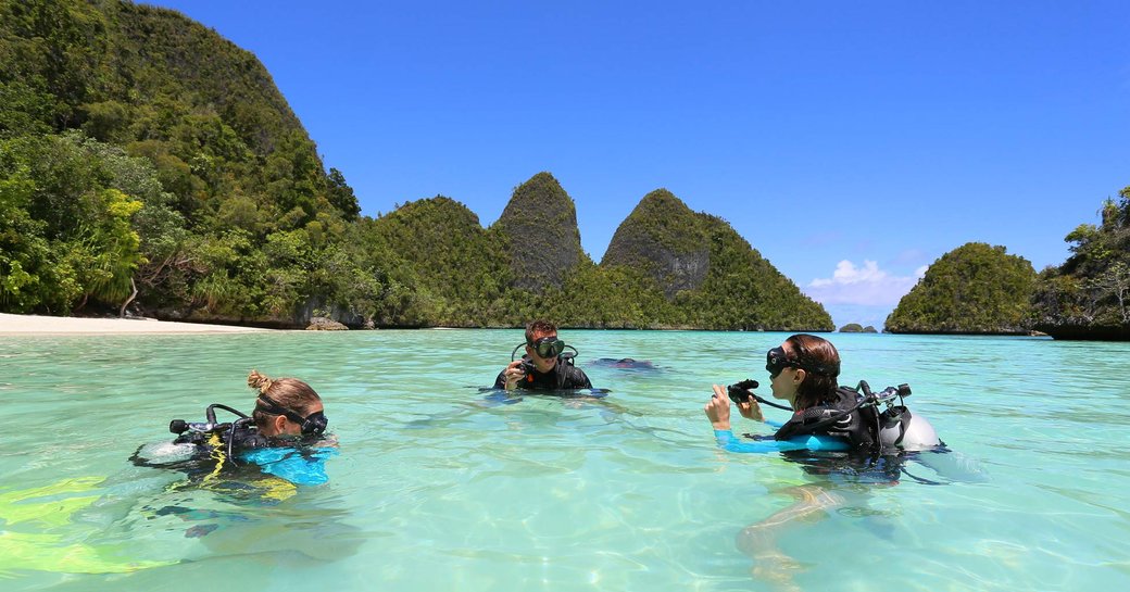 charter guests learn how to scuba dive in the turquoise waters of South East Asia