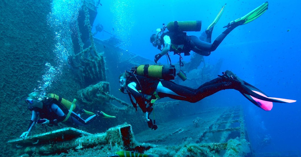 Scuba divers examine a wreck in Greece