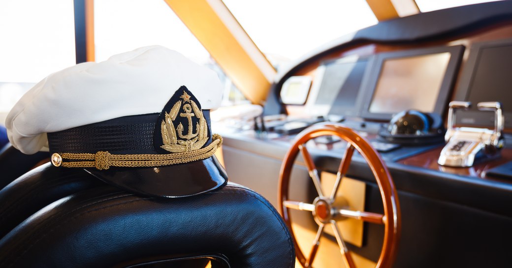 Close up of a captain's hat in a yacht's bridge 