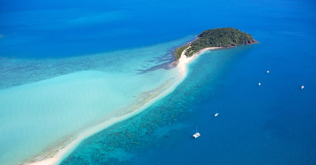 yachts anchored at Picturesque Langford island in tropical Whitsundays Australia. Aerial landscape view