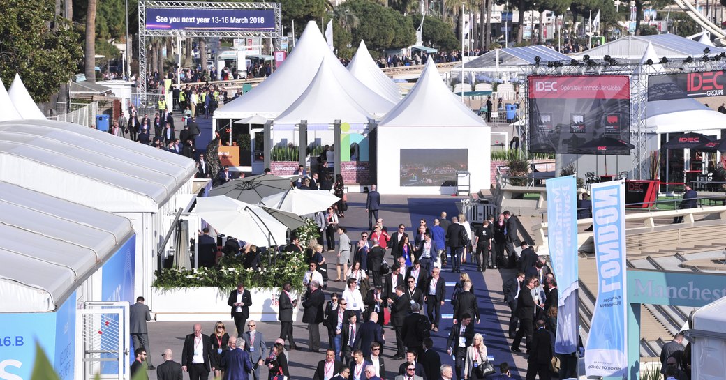 show-goers at MIPIM walk around the Palais de Festivals in Cannes