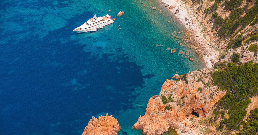 luxury charter yacht practising social distancing in sheltered cove