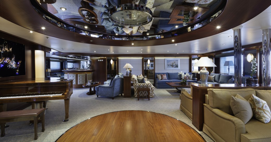 grand piano and seating areas in the main salon aboard superyacht Lauren L 